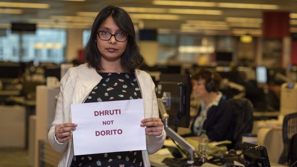 Dhruti holding sign saying 'Dhruti not Dorito'